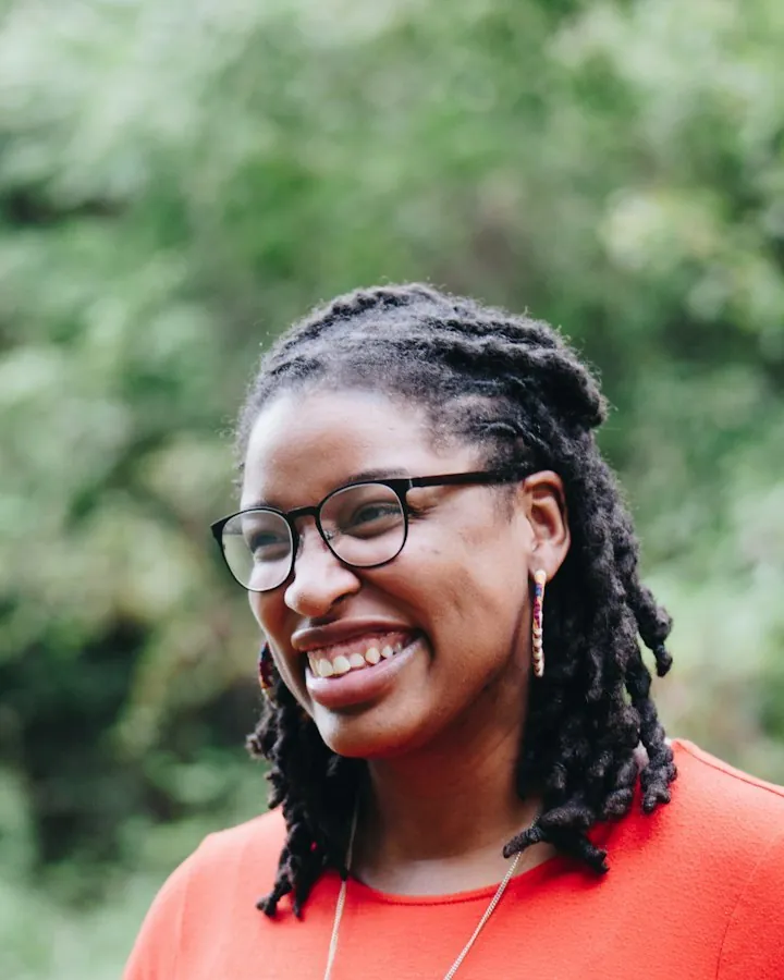 Smiling woman with shoulder length locs