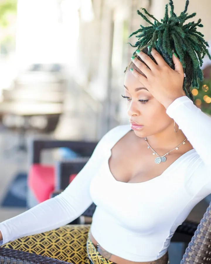 Woman with short green colored locs